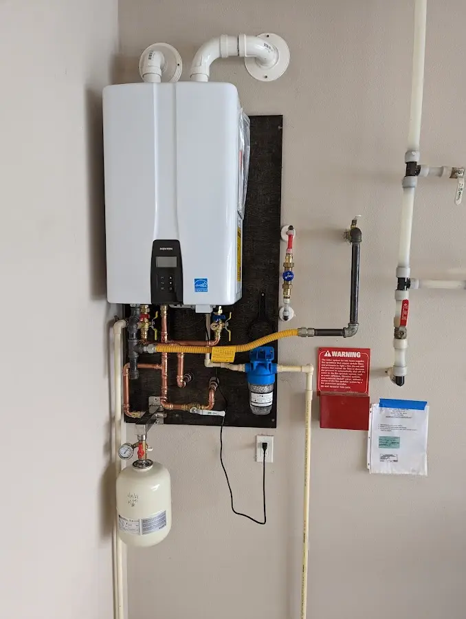 Professional plumber installing copper piping in a Granite Falls home